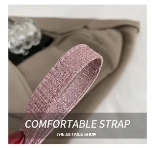 Detailed macro view of the sparkling pink glitter shoulder strap with textured finish