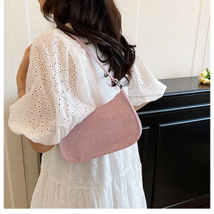 Detail shot of the pink sequined baguette bag showing the glitter texture and shoulder strap