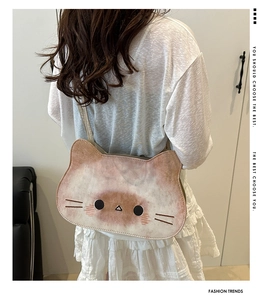 Detail showing the soft plush texture and cat facial embroidery on the cat-shaped tote bag
