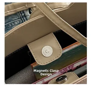 Detail of magnetic buckle closure on beige crossbody bag showing secure magnetic design