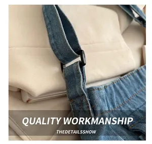Detailed macro view of denim fabric with yellow stitching and black square adjustment buckle
