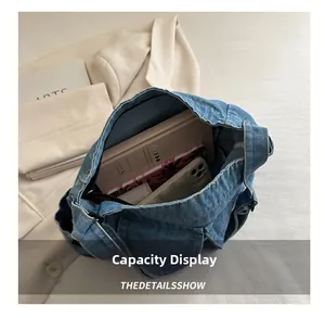 Spacious interior of blue denim tote bag showing capacity for books and essentials