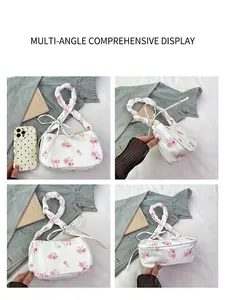 Detail view of white shoulder bag with floral rose prints and ruched handle design