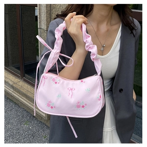 Pink floral shoulder bag with rosette bow patterns and ruched adjustable handle strap