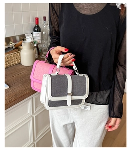 Close-up of stylish mini handbags with woven texture, leather trim and metal buckles