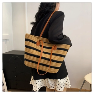 Detailed close-up of woven cotton strap on large striped beach tote bag for women