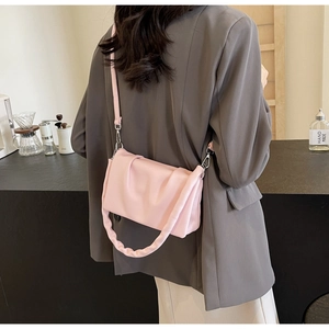 Detail showing soft pleated texture and chunky gathered handle of light pink crossbody bag