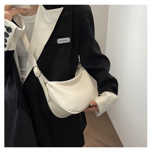 Detailed view of the white PU leather crescent bag worn as a crossbody shoulder style