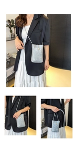 Detail of silver textured mini crossbody bag featuring a large pearl clasp and rope strap