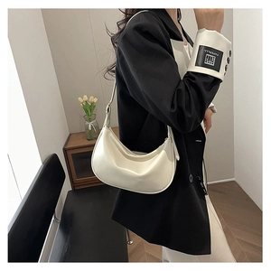 Detailed close-up of a white PU leather hobo bag with adjustable shoulder strap