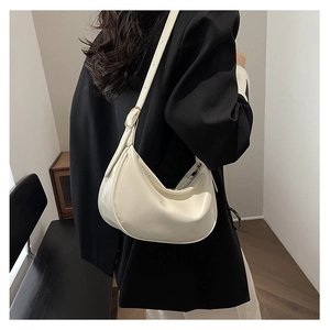 Detailed view of cream PU hobo bag with smooth texture and adjustable strap on model