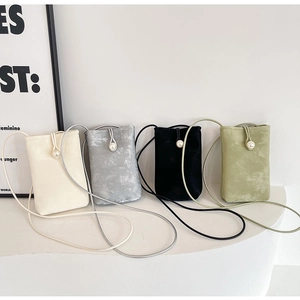 Detail of four colorful mini crossbody bags with pearl fasteners and matte texture
