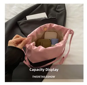 Pink drawstring cloud bag interior capacity display showing phone and makeup storage