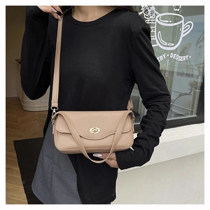 Chic beige leather shoulder bag with gold twist lock shown in a modern urban setting