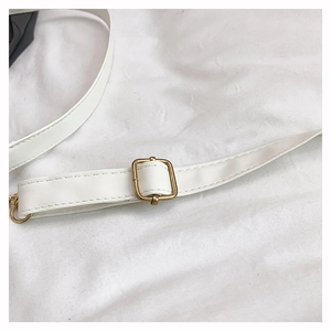 Detail of white leather shoulder strap with gold adjustable metal buckle and stitching