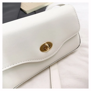 Detail of minimalist cream leather handbag with premium golden twist lock closure