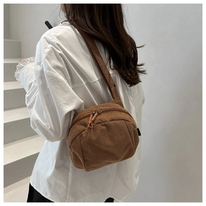 Détail du sac bandoulière en velours côtelé marron avec bandoulière et fermeture