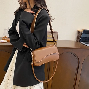 Sac bandoulière marron en cuir avec rabat à coupe ondulée et boucles dorées