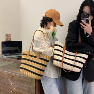 Woven striped cotton tote bag with leather handles in black, white, and yellow colors