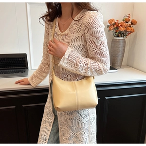 Détail du sac seau blanc crème avec coutures parallèles sur similicuir lisse brillant