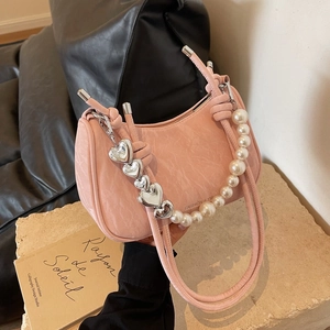 Pink minimalist shoulder bag with pearl handle and silver heart chain detail