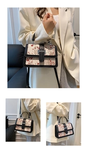 Detail of beige jacquard square bag with red floral embroidery and silver metal clasp