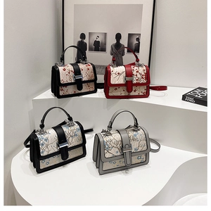 Detail view of Chinese style embroidered floral handbags with metal clasp and top handle