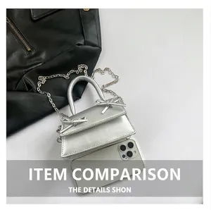 Mini silver metallic bag with bow detail showing size comparison to a smartphone