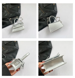 Detail view of mini metallic handbag featuring silver bows and detachable chain strap