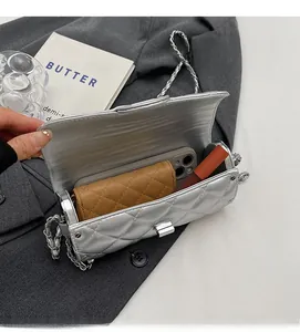 Vue intérieure du sac cylindrique argenté matelassé avec rangement pour téléphone et maquillage
