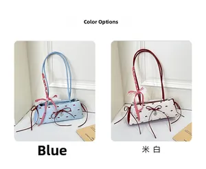 Detail view of contrast polka dot handbags in blue and cream with red bows and charms
