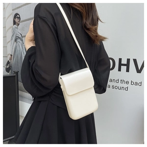 Detailed side view of a minimalist cream-white phone crossbody bag with adjustable strap