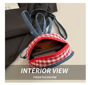 Interior view showing the capacity of the red gingham bag with denim rabbit ears