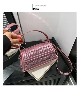 Detail of pink metallic handbag showing square quilting and crocodile skin texture