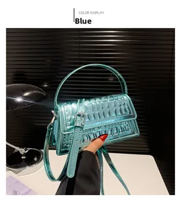 Close-up of blue glossy crocodile pattern handbag with silver metallic hardware and strap