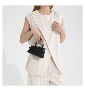 Chic black mini trapezoid leather handbag with dual bow knots and chain strap