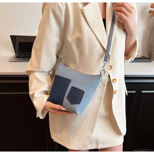 Details der blauen Denim-Patchwork-Beuteltasche mit Kontrastnähten und Lederriemen