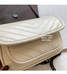 Detail showing the cream white V-shaped chevron quilted texture and soft leather finish