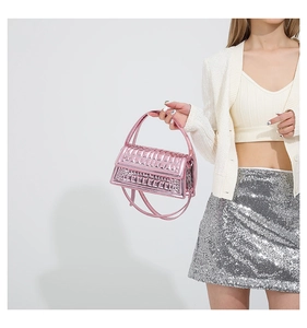 Detail of pink metallic handbag featuring rectangular quilting and crossbody strap