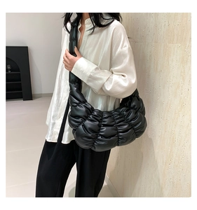 Detail view of the black ruched texture and soft puffed design on the cloud shoulder bag