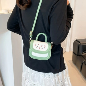 Mini green and white handbag with cherry print and adjustable shoulder strap for women