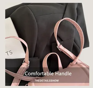 Detail of pink leather backpack handle with silver hardware and precision stitching