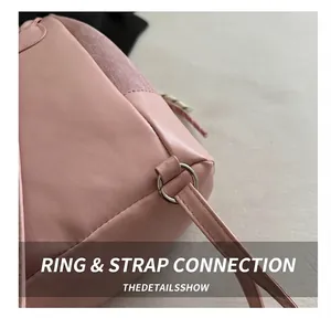 Close-up of pink leather backpack silver metal buckle and precision stitching detail