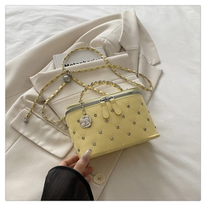 Detailed quilted yellow leather shoulder bag with metallic handle and camellia charm accent