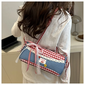Detail of lace trim and Sweet Cherry patch on blue denim and red plaid handbag