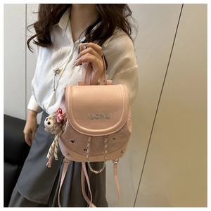 Detailed pink mini backpack showing embroidery, chain detail and plush bear charm accessory