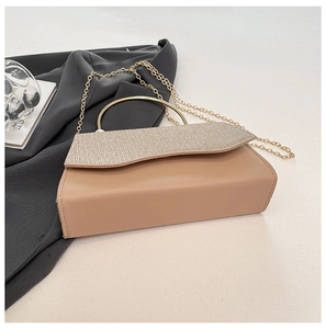 Détail du rabat scintillant et de la poignée dorée sur un sac à main élégant