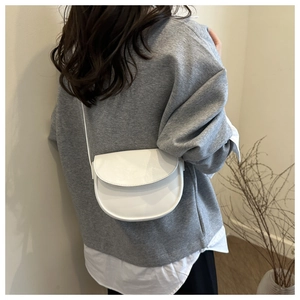 Model wearing white saddle bag showing back view proportions and elegant style