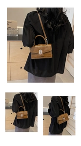 Detail of brown crocodile pattern shoulder bag featuring metal twist lock and handle