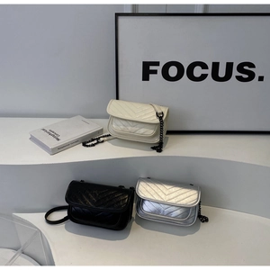 Three chevron quilted flap crossbody bags in white, black, and silver with matte chains